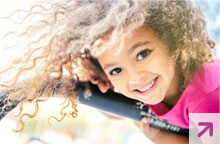 Young girl playing on the playground and smiling.